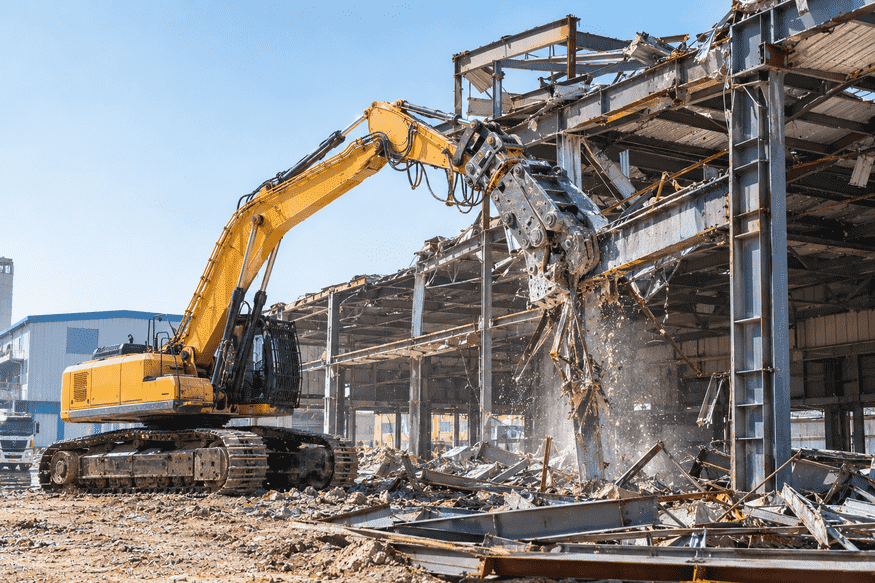 Steel structure dismantling by excavator with hydraulic shear in Dubai