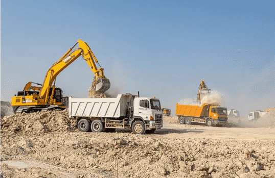 Concrete building demolition by excavator in Dubai