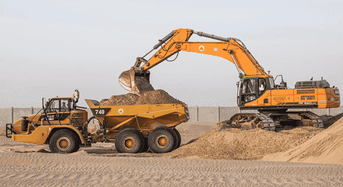 Demolition contractors at work with an excavator on a UAE site